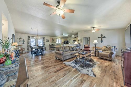 a living room with couches and a ceiling fan at Charming Ruidoso Home with Deck and Lovely Views! in Ruidoso