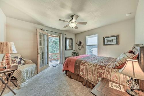 a bedroom with a bed and a ceiling fan at Charming Ruidoso Home with Deck and Lovely Views! in Ruidoso