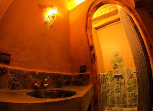 a bathroom with a sink and a mirror at Auberge Kasbah Dar Sahara Tours in Mhamid