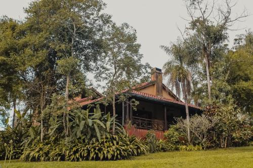 a house with a bunch of trees in front of it at Reserva Natural Iguazú - Posada Puerto Bemberg in Puerto Libertad