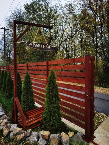 a red fence with a sign that reads apr apartment at Odmaraliste Kod Miće Apartman 3 in Krušar