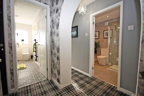a bathroom with a walk in shower and a toilet at Rhoslan. Boutique style farmhouse in Snowdonia in Caernarfon