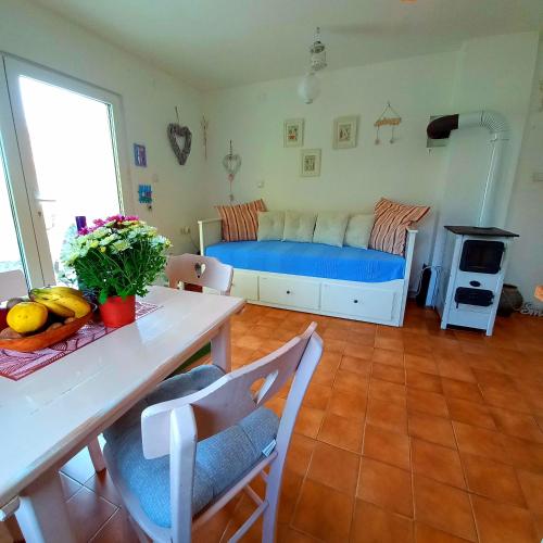 a living room with a bed and a table at Honey hill apartment Fruska Gora in Čerević