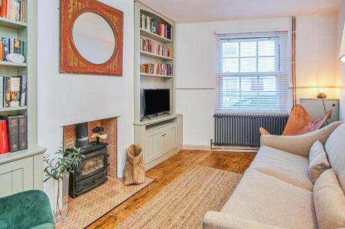 a living room with a couch and a fireplace at Insignia in Cowes