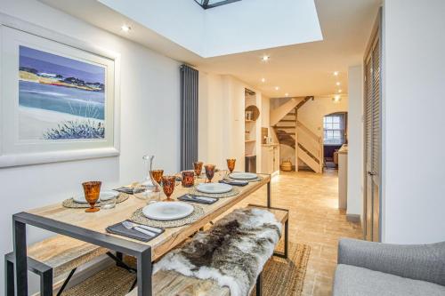 a dining room with a table and a couch at Insignia in Cowes