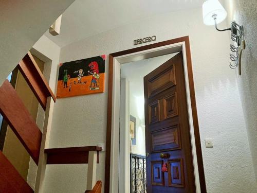 a hallway with a staircase and a door with a sign at Apartamento Lina, a 20 metros de la playa in Lloret de Mar