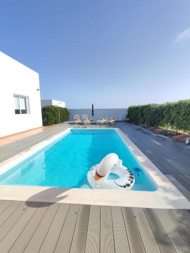 a swimming pool with a swan on the side of it at Casa Bermeja - Tiscamanita in Tiscamanita