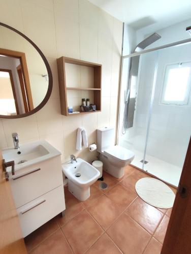 a bathroom with a sink and a toilet and a mirror at Casa Bermeja - Tiscamanita in Tiscamanita