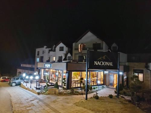 a building with a sign that reads nordorf at night at Apartman D&V Milmari Resort S10 in Kopaonik