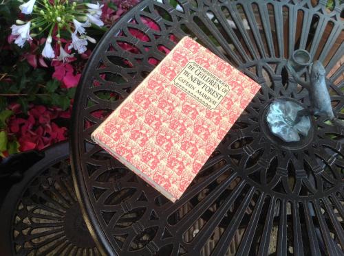 a red book sitting on top of a metal table at THE KNIGHTWOOD OAK a Luxury King Size Bed - En-Suite Space - LYMINGTON NEW FOREST with Totally Private Entrance - Key Box entry - Free Parking & Private Outdoor Seating Area - Town ,Shops , Pubs & Solent Way Walking Distance & Complimentary Breakfast in Lymington