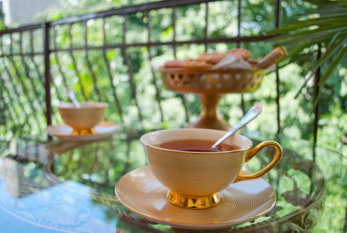 a cup of tea on a glass table with a bowl of food at Hotel British House in Tbilisi City