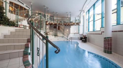 a swimming pool in a building with stairs at Superior Hotel Panorama in Obertauern