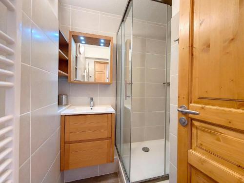 a bathroom with a shower and a sink and a mirror at Appartement rénové Au pied des pistes Balcon ouest - FR-1-344-769 in Les Menuires