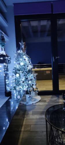 a christmas tree with lights on a table at Paraiso Azul Villas in Áyios Dhimítrios