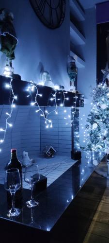 a room with a christmas tree and a table with wine glasses at Paraiso Azul Villas in Áyios Dhimítrios