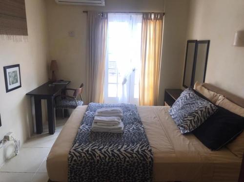 a bedroom with a bed with towels on it at Moxons Beach Club in Boscobel