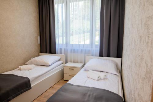 Postel nebo postele na pokoji v ubytování Apartamenty Leśne Zacisze