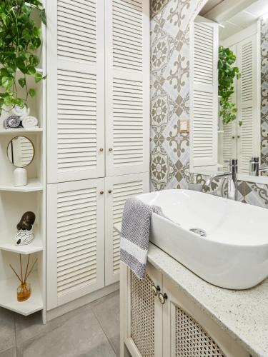 a bathroom with a white tub and a sink at Estia Residence in Chania Old Town in Chania