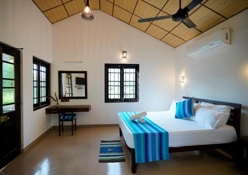 a bedroom with a bed and a desk in a room at Ranakeliya Lodge - Yala in Yala