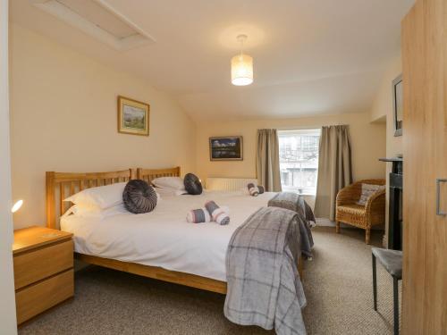a bedroom with a bed with two pillows on it at 21 Entry Lane in Kendal