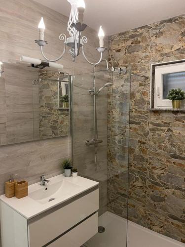 a bathroom with a sink and a glass shower at Vila Kata in Zubovići