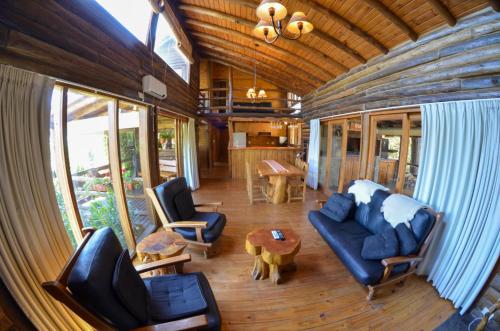 a living room with a couch and chairs and a table at LA LINDA - Cabaña de Montaña in Villa Berna