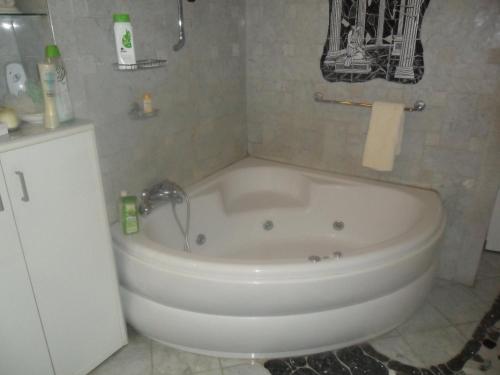 a white bath tub in a bathroom with a sink at Luxury near Castle in Vienna