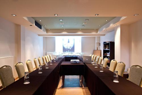 a long table in a room with chairs at Kipi Mountain Resort in Kipoi