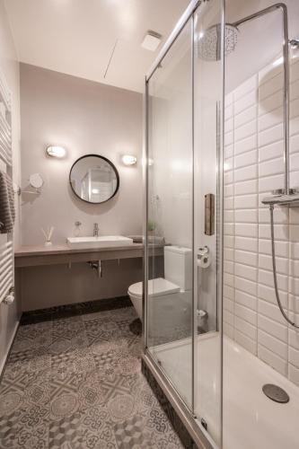 a bathroom with a shower and a toilet and a sink at The Pearl of the Heart of Budapest in Budapest