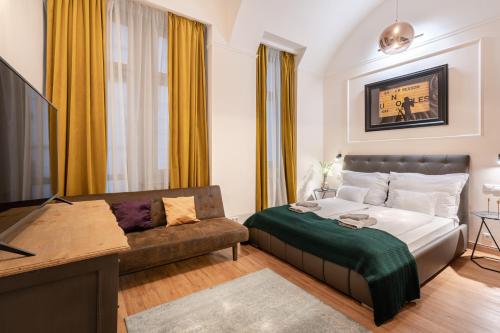 a living room with a bed and a couch at The Pearl of the Heart of Budapest in Budapest