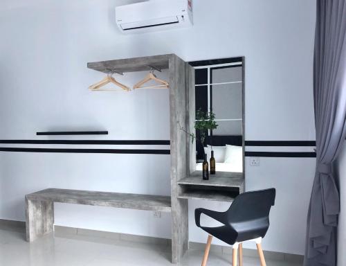 a table and a chair in a room with a mirror at Atlantis Residences 1BR By 360 HOME in Melaka