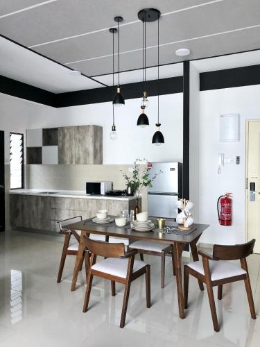a dining room with a wooden table and chairs at Atlantis Residences 1BR By 360 HOME in Melaka