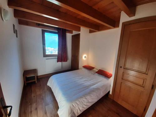 ein Schlafzimmer mit einem weißen Bett und einem Fenster in der Unterkunft Appartement Aussois, 3 pièces, 6 personnes - FR-1-508-245 in Aussois