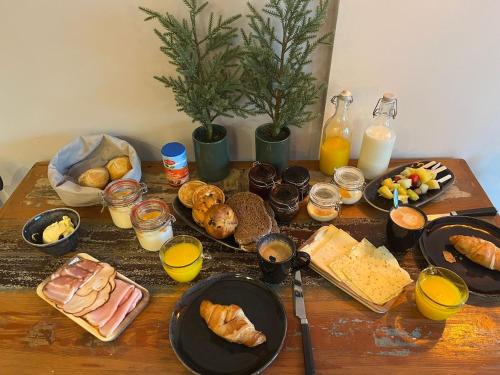 a table topped with plates of food and drinks at B&B Stoet & Berre Geheel privé 1 - 4 pers in Assen