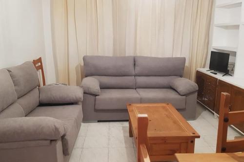 a living room with a couch and a table at Adosado Dr Fleming 12 in Poyales del Hoyo