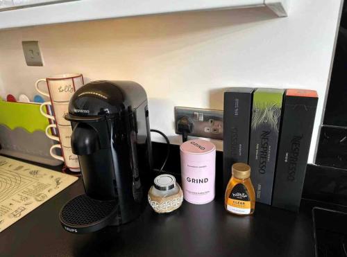 a coffee maker sitting on a counter next to books at Amazing Getaways - The Place for You with Free Parking in Aberdeen