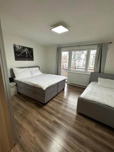 a bedroom with two beds and a window at Medena Apartment old town with free parking in Bratislava