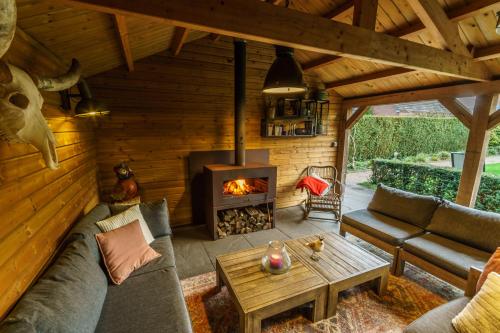 a living room with a couch and a fireplace at B&B De Boskamp in Tegelen
