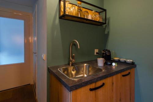 a kitchen with a sink and a counter top at B&B De Boskamp in Tegelen
