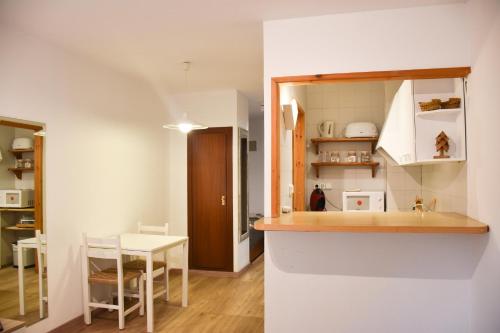 uma cozinha com um balcão e uma mesa num quarto em ESTUDIO AVET - Perfecta ubicación em Pas de la Casa