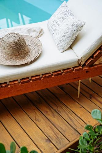 a bed with two pillows on a wooden bench at Pousada Sabina in Barra Grande