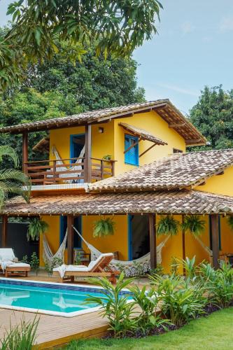 an exterior view of a house with a swimming pool at Pousada Sabina in Barra Grande