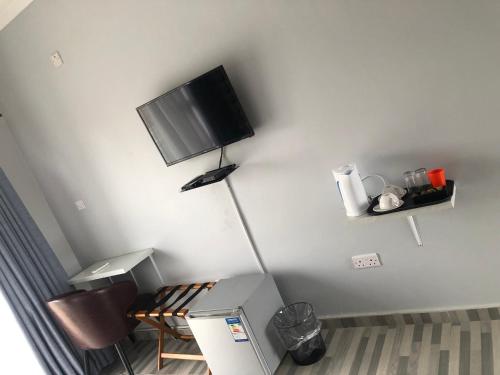 a room with a flat screen tv on the wall at Avrila Springs Hotel in Gaborone