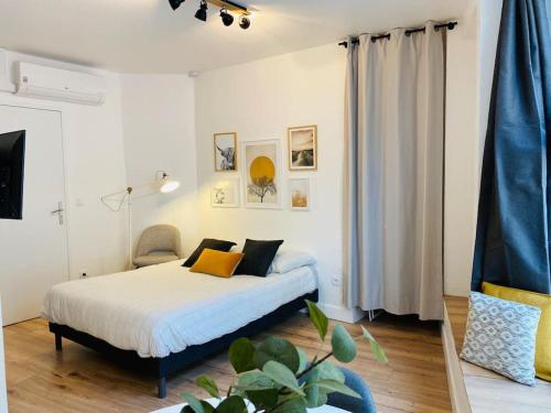 a bedroom with a bed and a chair in it at Les studios de Morgane hyper centre in Valence