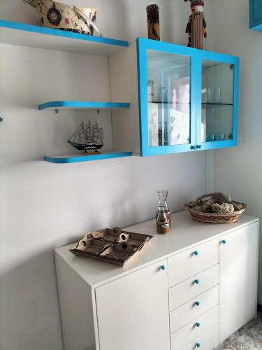 a room with a white cabinet and blue cabinets at Casa Mary in Marotta