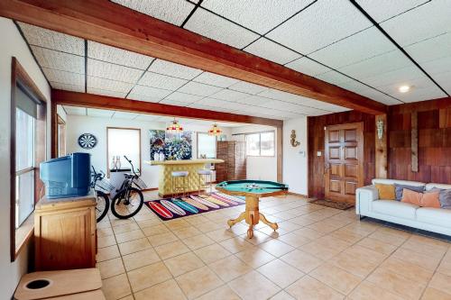 a living room with a pool table and a tv at Casa del Lago in Marble Falls