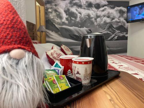 a christmas tray with a coffee maker on a bed at Romantica camera in Valtournenche