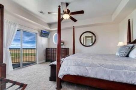 a bedroom with a bed and a ceiling fan at Summit Villa BnB in Watkins