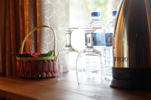 a group of bottles sitting on a table next to a window at Turtle Bay Beach Resort in Mirissa