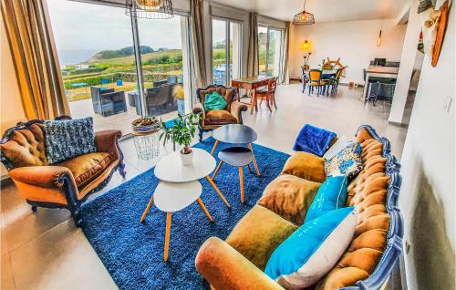 a living room with a couch and chairs and a table at Cozy Home In Plouarzel in Plouarzel